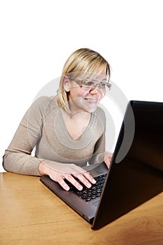 Joyful woman looking at laptop screen