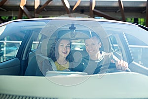 Joyful woman and man sitting in a passenger car