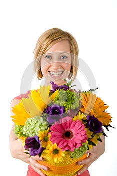 Joyful woman offers bouquet