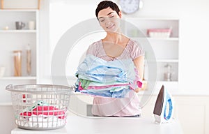 Joyful Woman with a pile of clothes