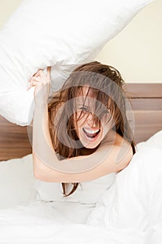 Joyful woman with pillow