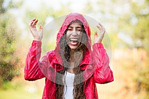 Joyful woman playing in rain