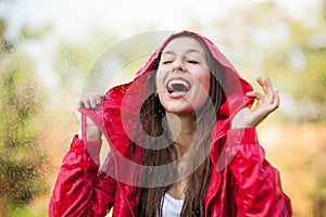 Joyful woman playing in rain