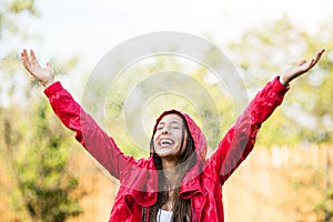 Joyful woman playing in rain