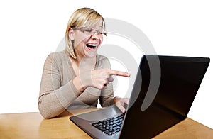 Joyful woman pointing at laptop screen