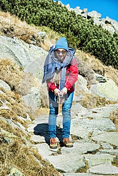 Joyful woman posing on the mountain footpath leading up the peak