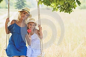 Joyful woman swinging with her child