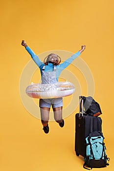 Joyful woman travelling abroad with bags