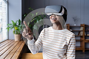 Joyful woman in virtual reality glasses headset touching vr screen use modern augmented technology