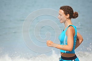 Joyful woman wearing sporty clothers is running. photo