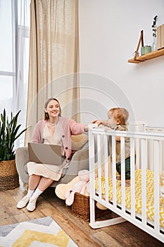 joyful woman working on laptop near