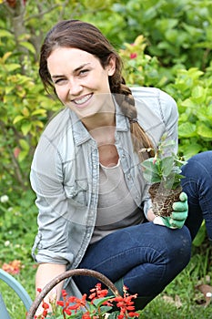 Joyful woung woman gardening