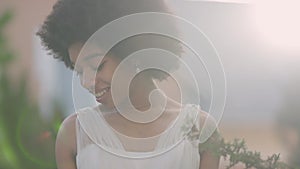 Joyful young bride in white wedding dress enjoying sunrays outdoors in summer garden. portrait of smiling cheerful happy