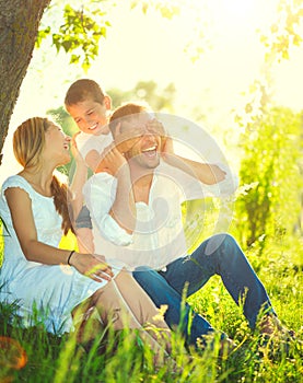 Joyful young family having fun outdoors