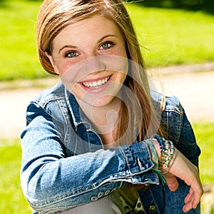 Joyful young girl enjoying sunshine outdoors