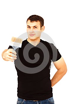 Joyful young man with a paint brush in right hand