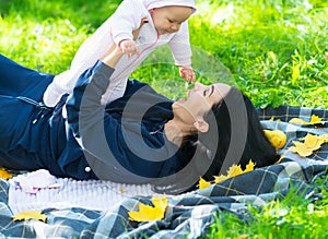 Joyful young mother playing with a small daughter.