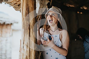Joyful young woman enjoying a tropical vacation at a beach hut
