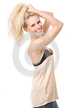 Joyful young woman with hands in hair
