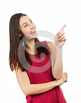 Joyful young woman pointing up