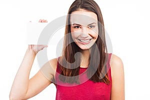 Joyful young woman showing a blank card