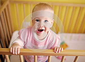 Joyfull child in crib