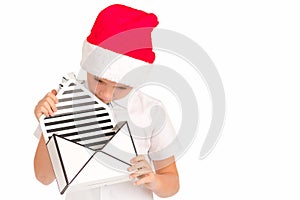 Close up joyless boy with red hat of Christmas on a over white background He look at empty gift box photo