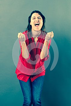 Joyous 30s woman shouting with euphoric body language
