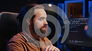 Joyous IT admin looking at PC screen, pleased after solving script errors