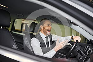 joyous appealing businessman in smart black