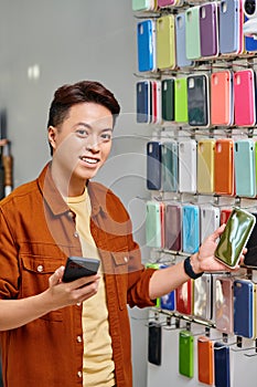 joyous asian man with mobile phone