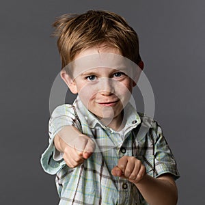 Joyous boy with freckles playing like a super hero