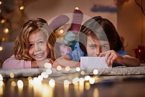 Joyous boy and girl watching cartoons with cellphone