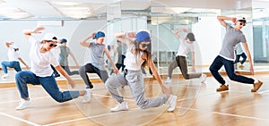 Joyous boy and girls dancing hip hop at lesson in the class