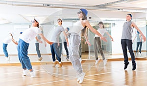 Joyous boy and girls dancing hip hop at lesson in the class