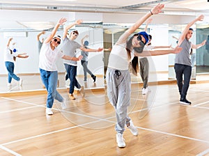 Joyous boy and girls dancing hip hop at lesson in the class