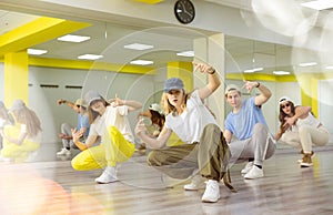 Joyous boy and girls dancing hip hop at lesson in class