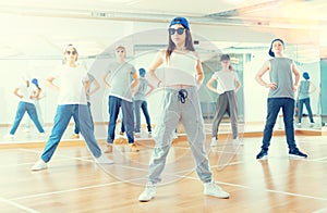 Joyous boy and girls dancing hip hop at lesson in the class