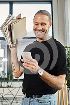 joyous businessman in casual attire holding