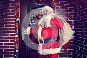 Joyous coming Santa Claus in home for Christmas photo