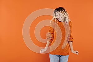 joyous and curly woman in bright