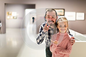 joyous father and daughter exploring expositions in museum