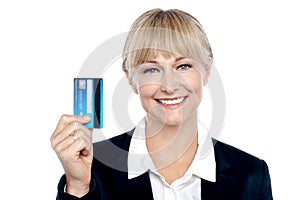 Joyous female employee showing credit card