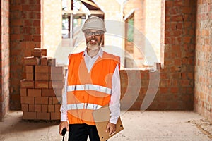 Joyous foreman posing for camera during building site inspection