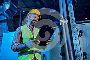 joyous hardworking technician in safety clothes