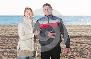 Joyous husband and wife spend time together happily at sea beach