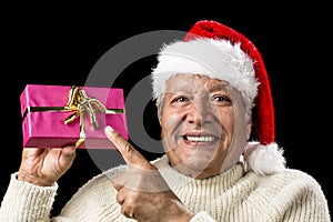 Joyous Old Man Pointing At Magenta Wrapped Gift