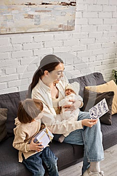 joyous pretty woman sitting on sofa