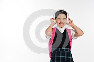 joyous schoolgirl in wireless headphones listening
