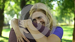 Joyous woman passionately embracing afro-american boyfriend, happy couple